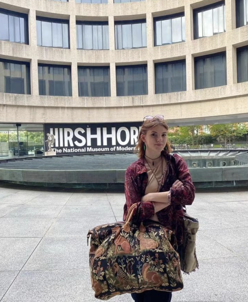 Me, standing with a luggage bag, in front of the Hirshhorn Museum