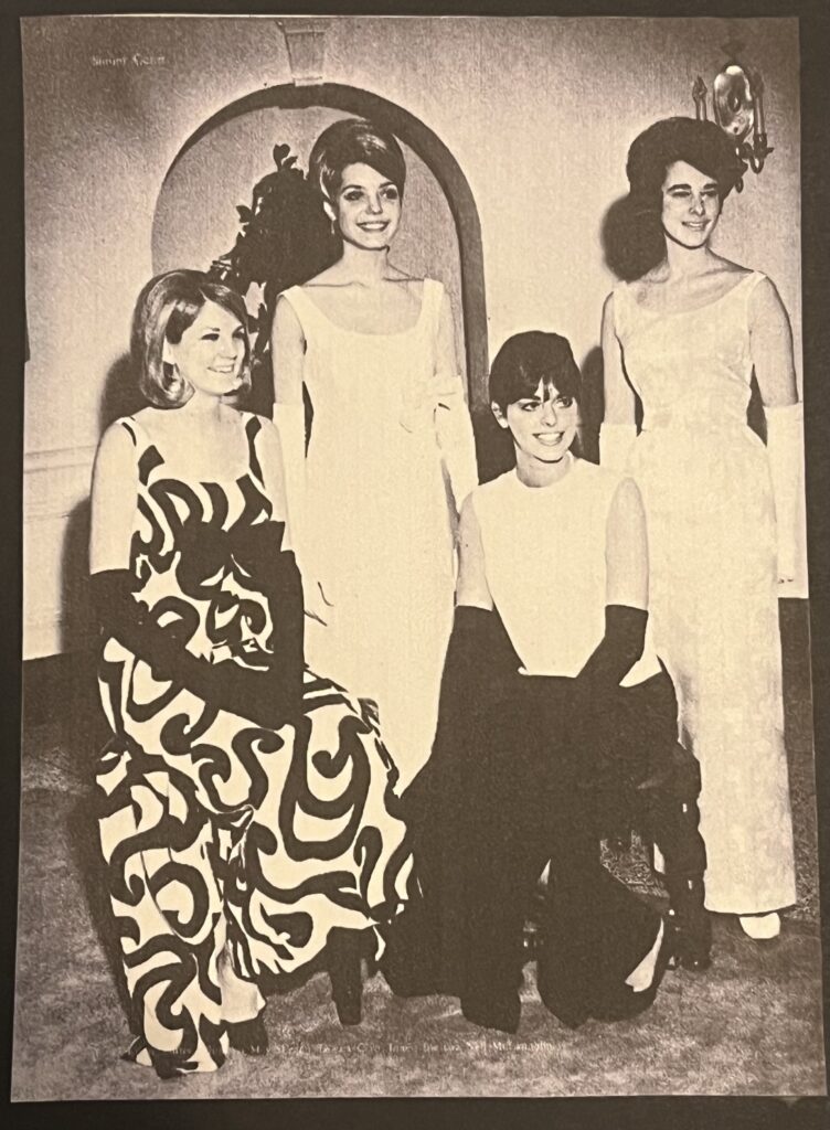 The Queens court. 4 girls siting and standing in a row. Black and white image.